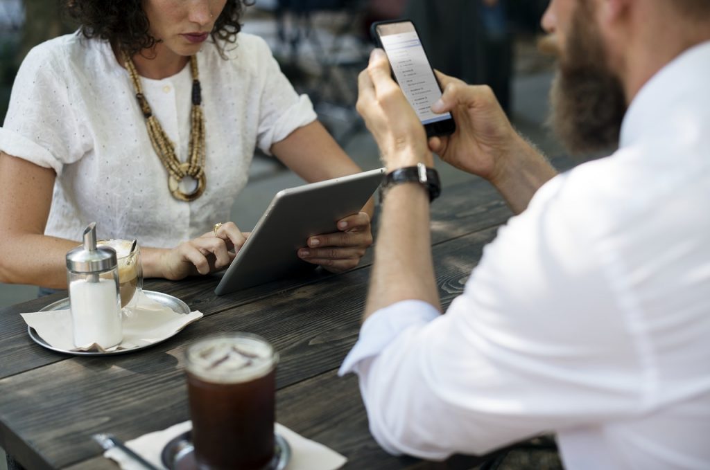 Small business owner taking a contactless mobile payment from a customer